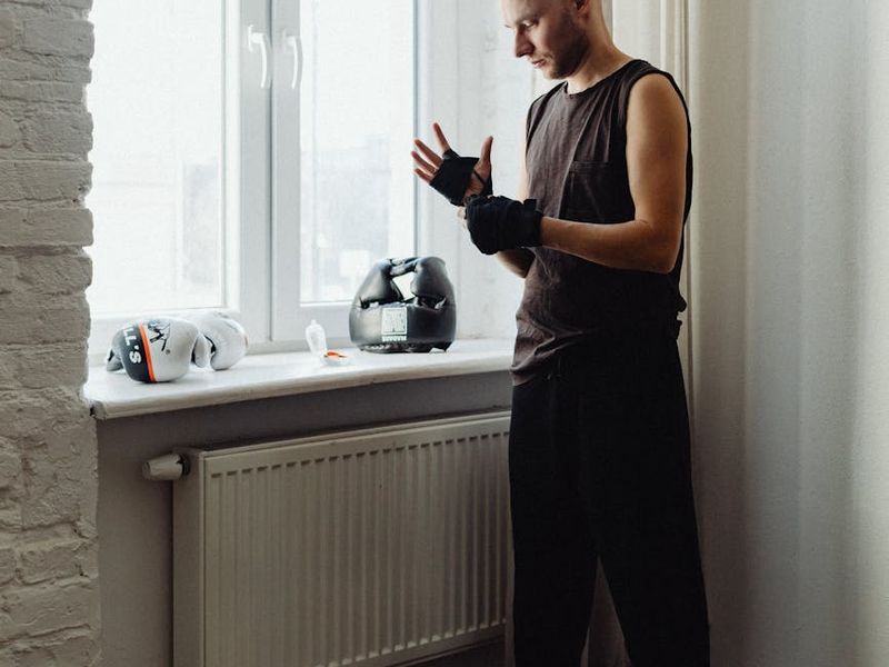 A focused man in athletic gear preparing for a workout session.
