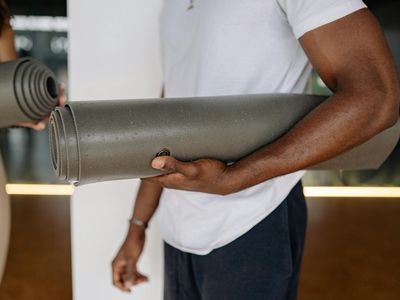 Close-up of athletic shoes on a yoga mat, symbolizing preparation.